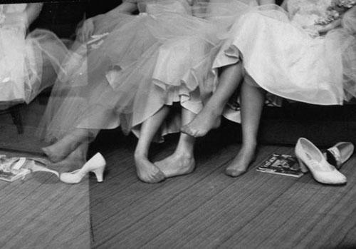 Girls resting their feet at first formal dance at the Naval Armory, 1956<br/>