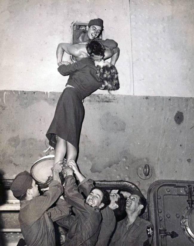 Marlene Dietrich passionately kissing a GI as he arrives home from World War II, New York, 1945 (This image was featured on the cover of<br/>