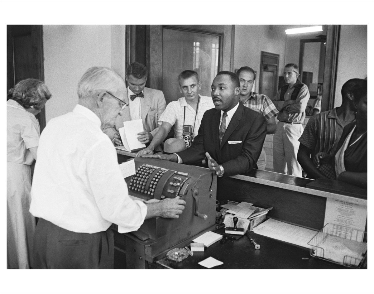 Martin Luther King at Police Headquarters, as he argued to  reject bail and  serve his sentence for disturbing the peace in Montgomery, Alabama, 1958