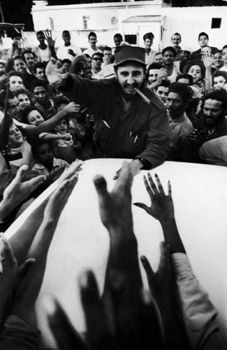 Rebel leader Fidel Castro  being cheered by a village crowd on his victorious march to Havana, 1959