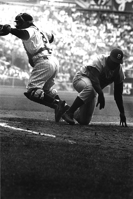 Brooklyn Dodger Jackie Robinson  steals home base against NY Yankees in the 8th inning of the 1st game of the World Series at Yankee Stadium, September 28, 1955