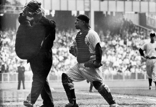 NY Yankee catcher Yogi Berra arguing with the home plate umpire who is walking away after giving the safe sign to Brooklyn Dodger Jackie Robinson's brilliant steal of home base in the 8th inning of th
