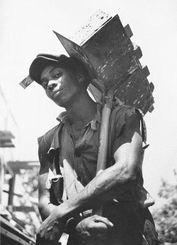 Carl Mydans Brick carrier at model community planned by the Suburban Division of the U.S. Resettlement Administration, Greenbelt, Maryland, 1936 (for the Farm Security Administration) (Time Inc.) 