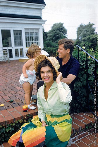 Jackie, Caroline, and John F. Kennedy on the patio of Joseph Kennedy's house, Hyannis Port. 1959