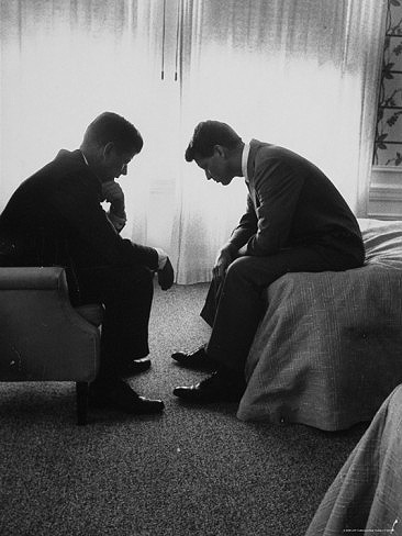 In a Los Angeles hotel suite, John F. Kennedy confers with his brother and campaign manager Bobby during the 1960 Democratic National Convention.