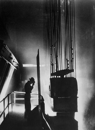 Photo: Ford Motor Company foreman shields his eyes against fiery light of open hearth mill, Detroit, MI 1929 Gelatin Silver print #1857