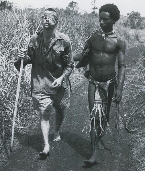 Blinded soldier, New Guinea (George Whittington being led to an aid station by Raphael Oimbari) 1942<br/>