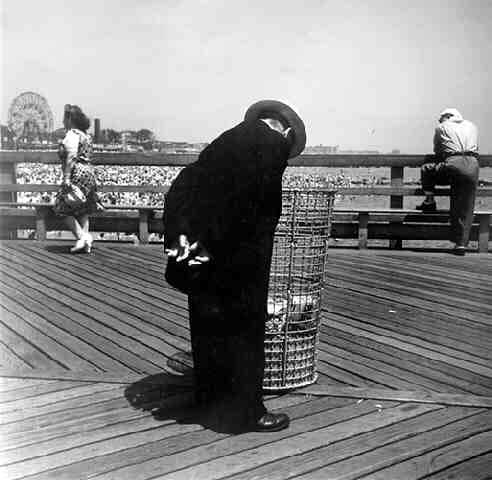 Ida Wyman Man Looking in Waste Basket, Coney Island, NY, 1945 