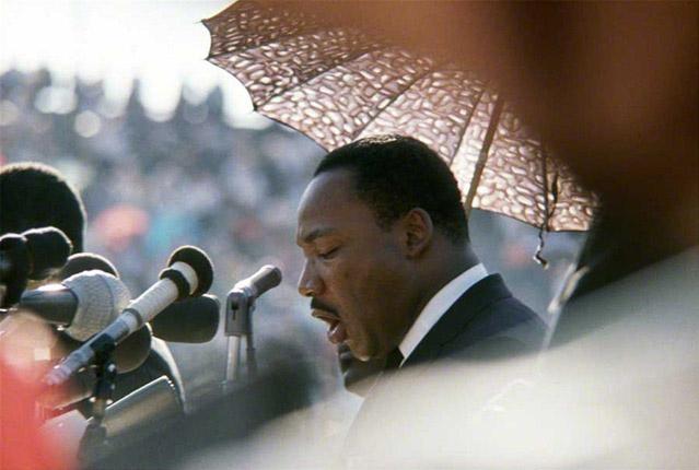 Martin Luther King speaking speaking at Soldier Field in Chicago during a large "freedom rally" which focused on housing discrimination, 1966<br/>