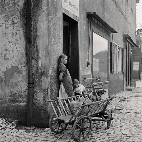 WaitingÂ For Mom. TwoÂ children wait outsideÂ a grocery store with the family shopping cart, Hoescht, Germany, 1946.Â 
