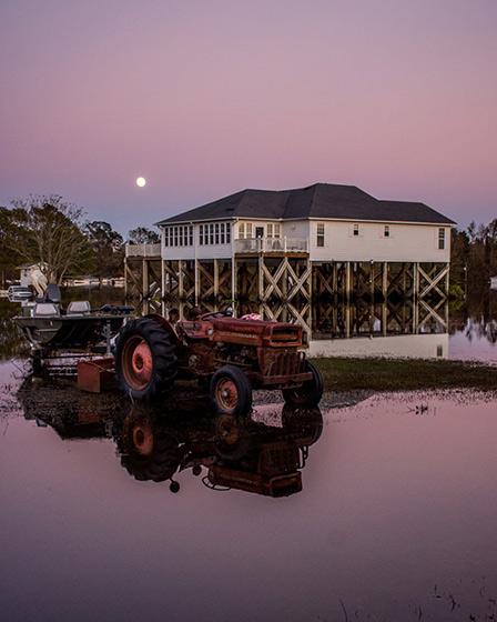 Photo: A home on narrowly escapes the flood as the sun sets in Rocky Point, 2018 Archival Pigment Print #2295