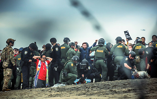 Religious leaders being arrested for peacefully protesting the immigration policies of the Trump administration, on the border near San Diego, California, December 10, 2018