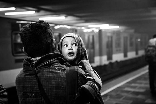 Photo: A father and child from El Salvador leaving Mexico City with 1500 other people on November 15, 2016 Archival Pigment Print #2336