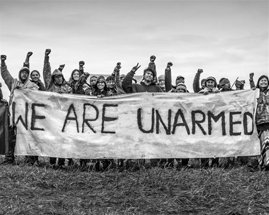 A banner that was hung at Oceti Sakowin Camp to remind law enforcement the camp was non-violent and was also carried during actions and marches through North Dakota during the Standing Rock movement, September 21, 2017<br/>