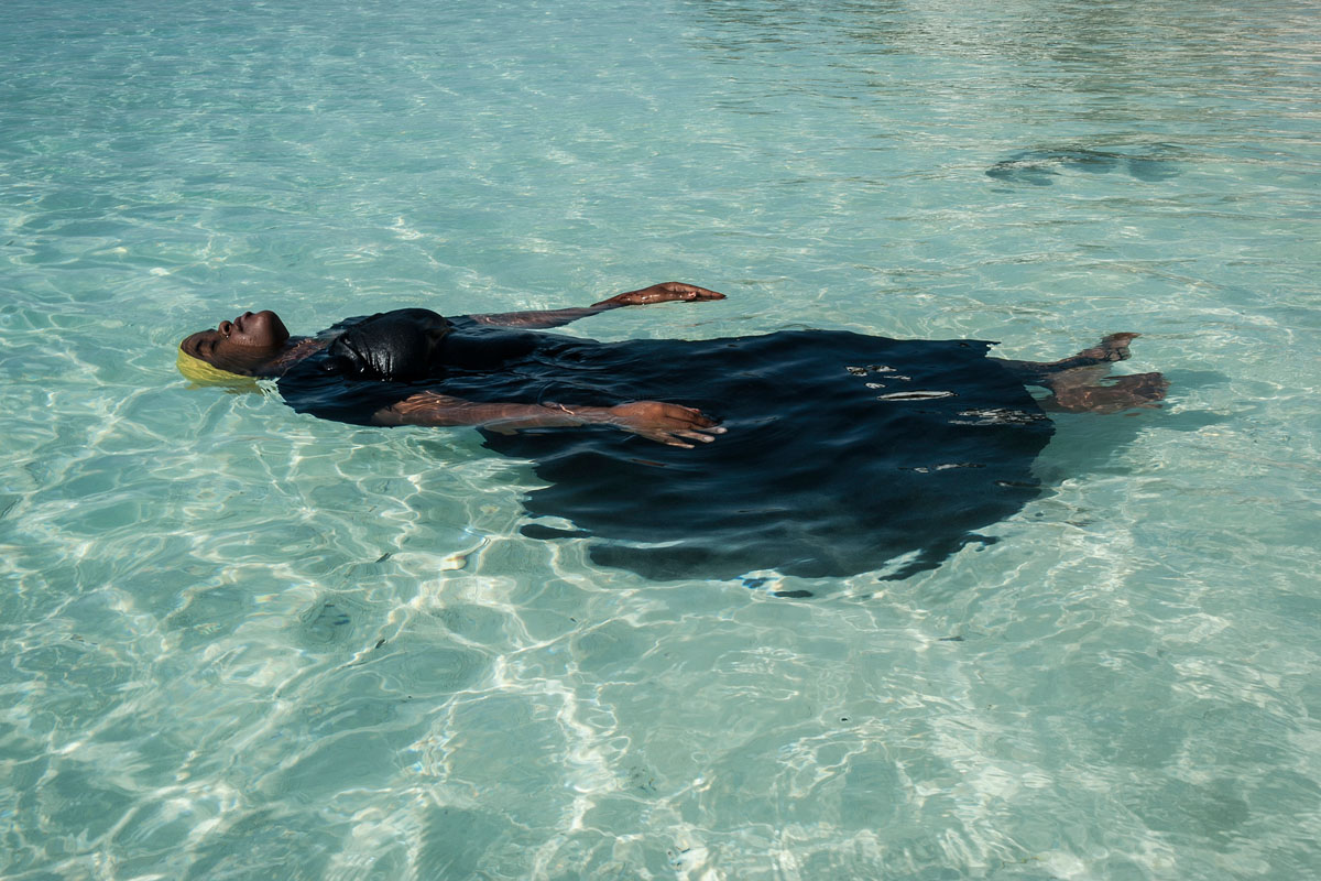 A young woman learns to float in the Indian Ocean off of Nungwi, Zanzibar, 2016