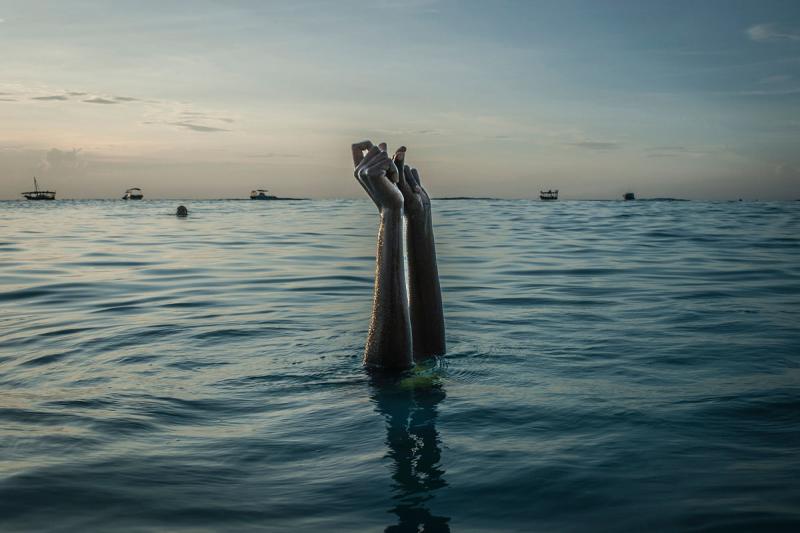 Photo: Swim instructor Chema, 17, snaps her fingers as she disappears underwater in Nungwi, Zanzibar, 2016 Archival Pigment Print #2413