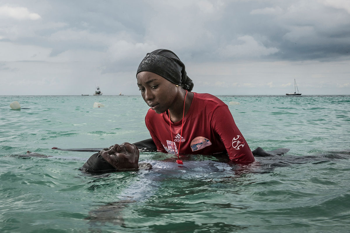 Swim instructor Siti, 24, helps a girl float in the Indian Ocean off of Nungwi, Zanzibar, 2016