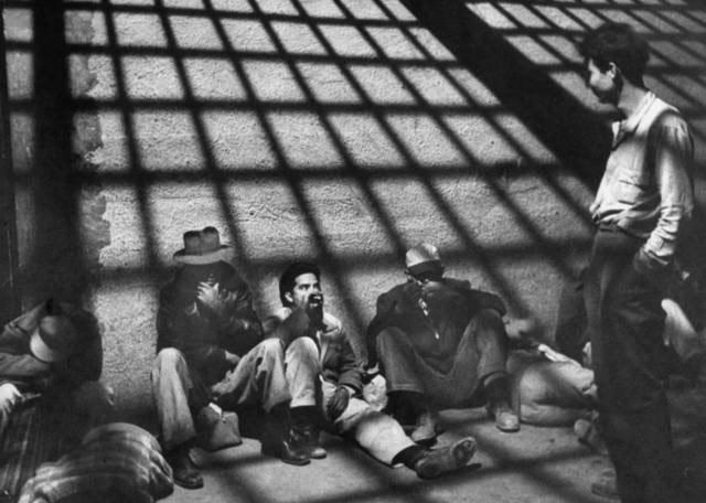 A group of illegal Mexican immigrants sprawled on floor of border patrol jail cell await deportation back to their homeland during "Operation Wetback", 1955<br/>