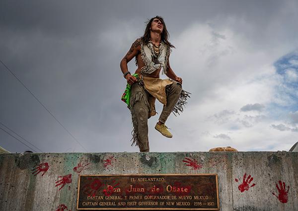 Than Tsídéh, 19, of the Ohkay Owingeh Pueblo dances on the empty platform where a statue of Juan de Oñate was removed,  Rio Arriba county, New Mexico, June, 2020<br/>