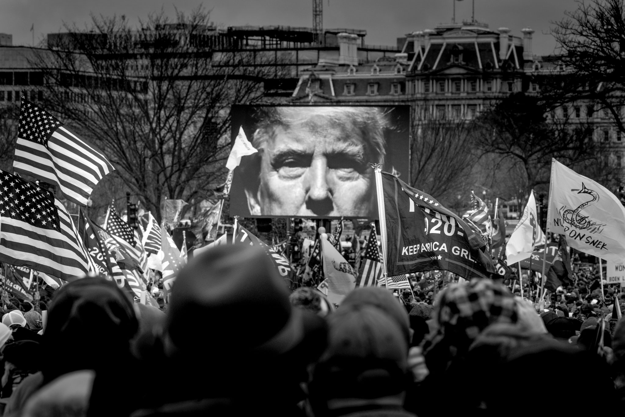 President Trump's image appears onscreen at a rally outside the White House. Before long, a mob of his supporters would march into the Capitol building, January 6, 2021