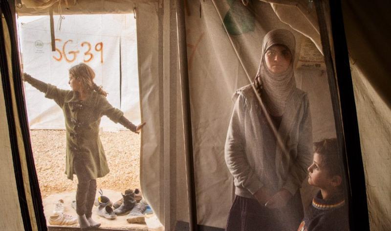 Ed Kashi A young girls spends time with her her siblings in her family tent at the Al Za’atri refugee camp near Mafraq, Jordan, 2013. With nearly 200,000 people, Al Za’atri is now the second largest refugee camp in the world.<br/>Please contact Gallery for price