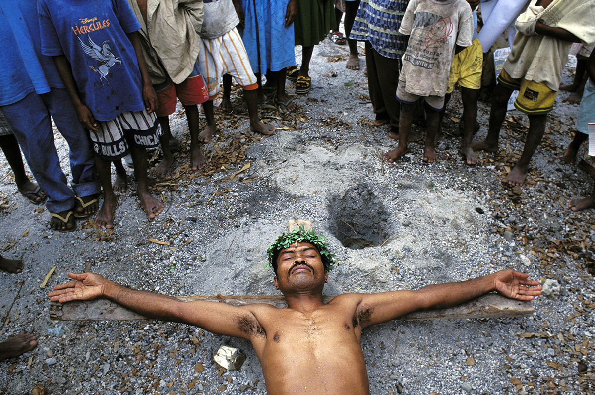 On Good Friday, Aetas who have converted to Christianity, perform penitence and enact the "stations of the cross," through the resettlement communities of Planas and Porac, Pampanga. Philippines, 1999