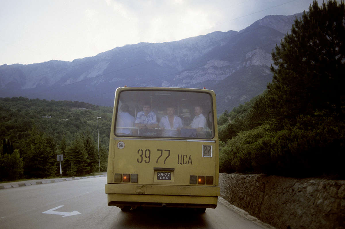 Travelers ride a trolley bus in Crimea, Ukraine, 1993. The trolley bus road is the first mountain road with overhead trolley line in the Soviet Union, running from Simferopol to Yalta