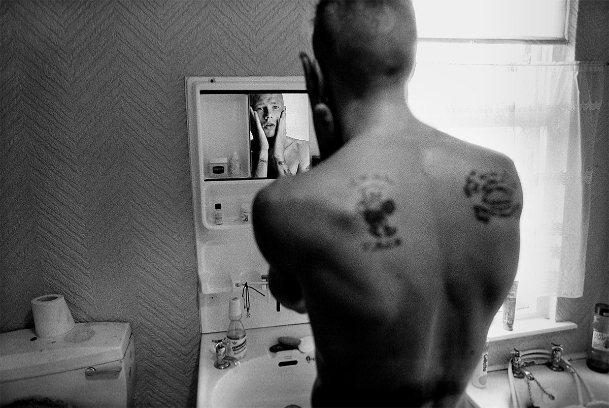 A teenager from Belfast’s working-class Protestant neighborhood of Tiger’s Bay, checks himself in the mirror in Belfast. Northern Ireland, 1989