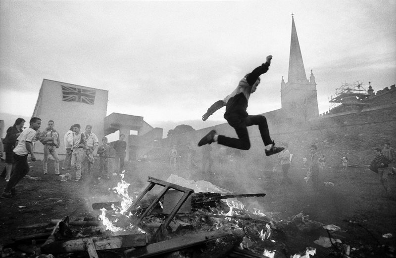 Photo: Youth gather around a makeshift bonfire in The Fountain, a Loyalist housing estate in a Protestant enclave of Londonderry, Northern Ireland, 1989 Archival Pigment Print #2600