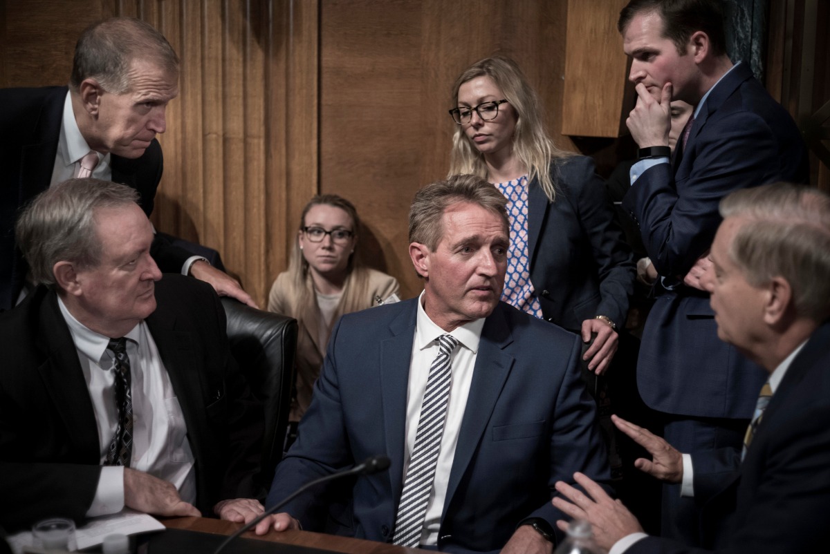 September 28, 2018. Arizona Senator Jeff Flake is surrounded by fellow Republicans Senatos. Thom Tillis (R-NC) above left, Mike Crapo (R-ID) and Lindsey Graham (R-SC), lower right. Flake had just appealed for a delay on Brett Kavanaugh's confirmation vote