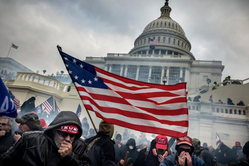 January 6, 2021. Supporters of President Donald Trump retreat from tear gas during a battle with Law Enforcement  officers on the west steps of the Capitol in Washington during the attack on the day of Joe Biden’s election certification by Congress Archival Pigment Print