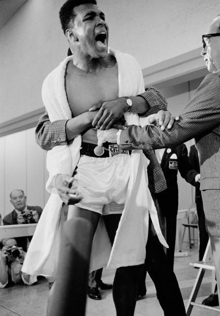 Cassius Clay (Muhammad Ali) restrained during weigh-in for Heavyweight Championship fight with Sonny Liston, Miami, 1964<br/>Please contact Gallery for price