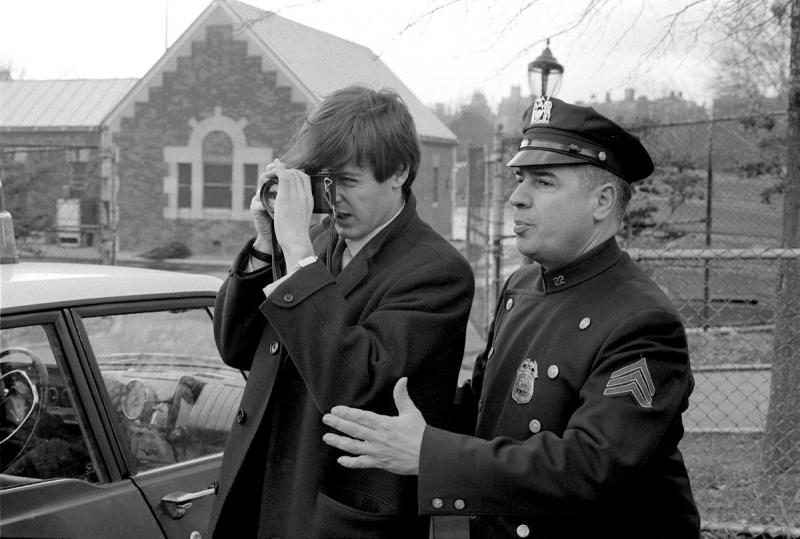 Paul McCartney with camera and Policeman, 1964<br/>Please contact Gallery for price