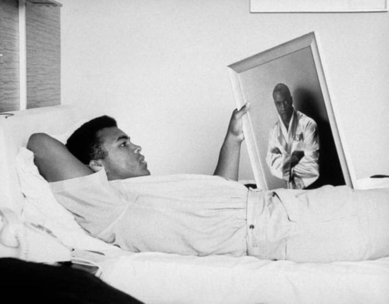  Cassius Clay (now Muhammad Ali) resting, holding picture of Sonny Liston, 1964<br/>Please contact Gallery for price