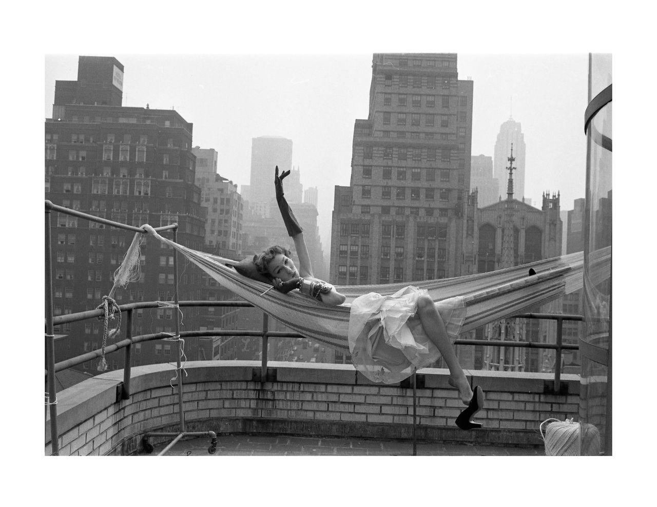 Model in hammock on the balcony of the LOOK building, New York, 1953