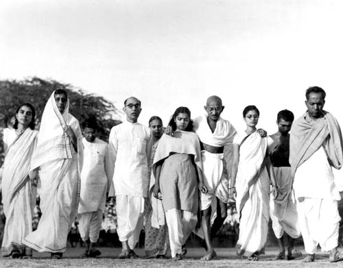 Gandhi walking with close advisors and family members, India, 1946