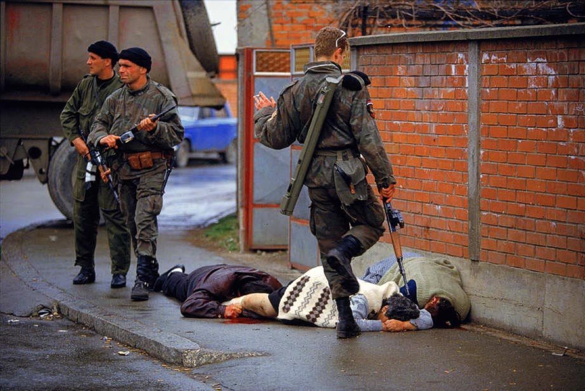 Members of Arkan's Serbian paramilitary group, the Tigers, execute unarmed Muslim civilians  during the first battle of the Bosnian war. This image was used as evidence in numerous  procedures to indict and convict people of war crimes. Bilijenia, Bosnia 