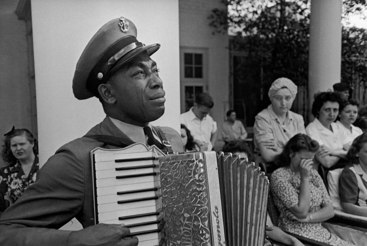 Accordion-playing Chief Petty Officer (USN) Graham Jackson as President Franklin D. Roosevelt’s flag-draped funeral train left Warm Springs, Ga., April 13, 1945