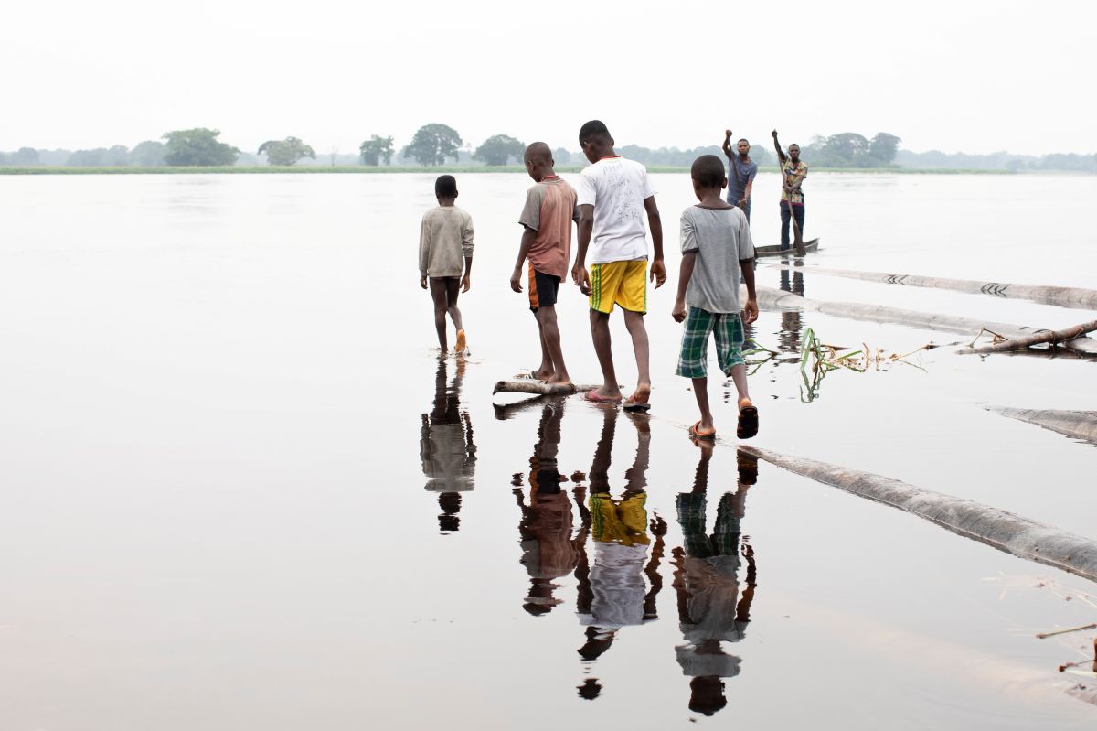 School children gathered along the Congo River, Democratic Republic of Congo, 2022