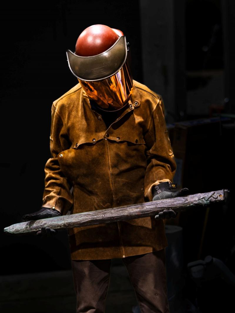 Photo: A foundry worker holds the sword of Robert E. Lee shortly before it is melted down, October, 2023 Archival Pigment Print #3028