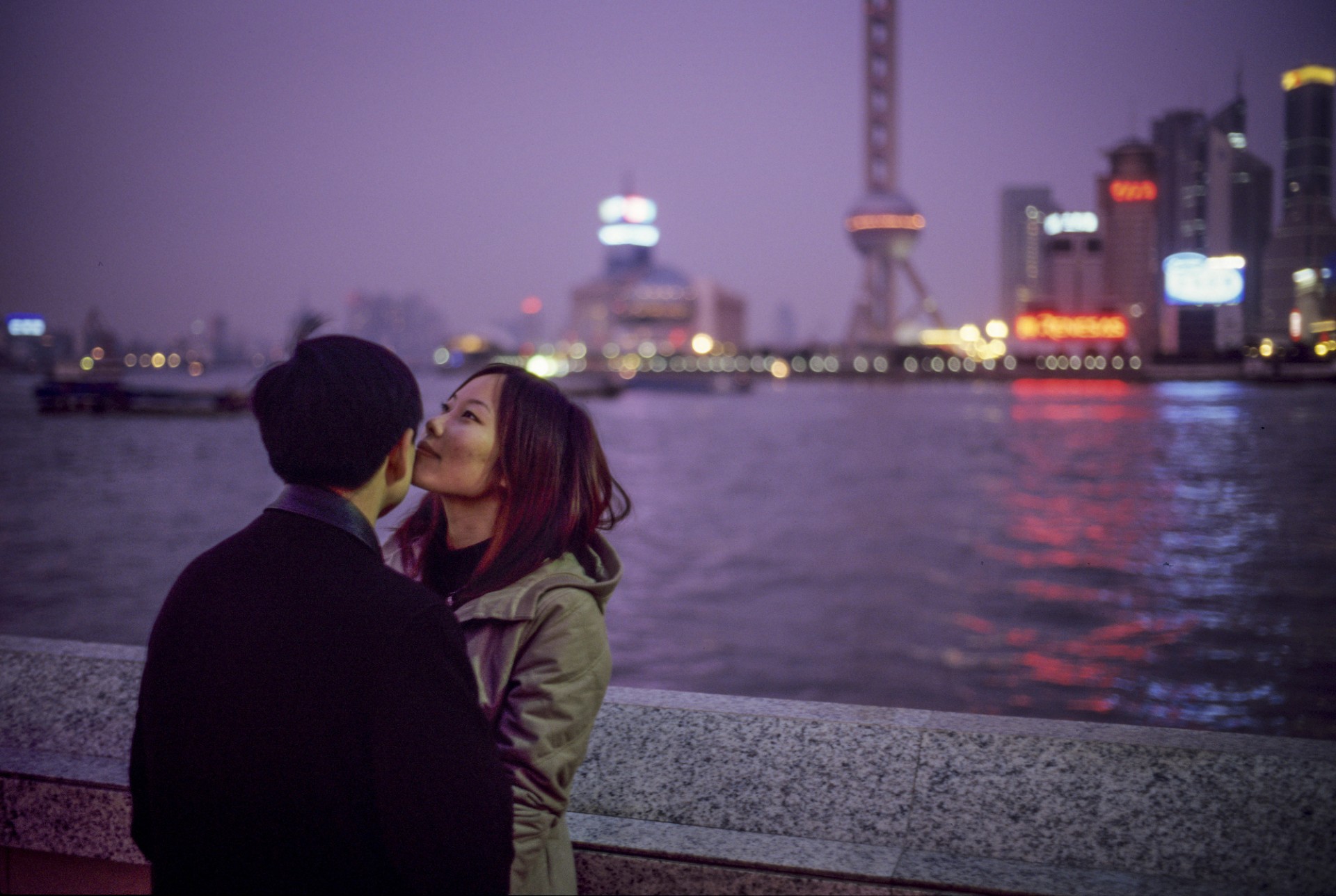  A couple shares a moment in the Puxi section of Shanghai along the Huangpu river district known as "The Bund."  ca. 2002