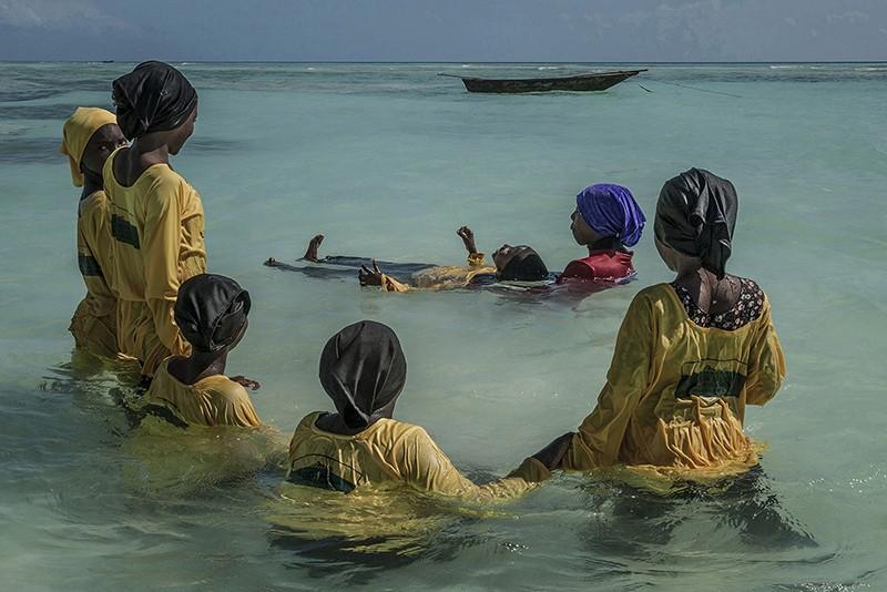 Photo: “Swim instructor Kazija, 22, teaches Kijini Primary School students how to float in the Indian Ocean off Muyuni, Zanzibar  #3130