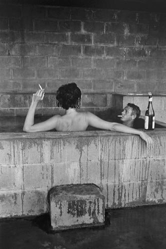 Steve McQeen and his wife, Neile Adams, in sulphur bath, Big Sur, California, 1963