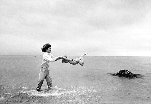 Jacqueline Kennedy swinging Caroline in surf, Hyannis Port, 1959