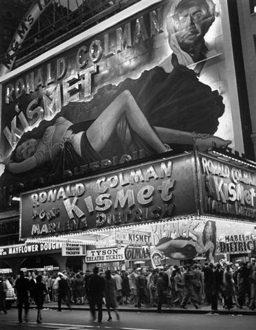 Huge billboard depicting Marlene Dietrich in Kismet over Astor Movie theater in Times Square, New York, 1944