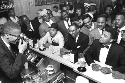 Black Muslim leader Malcolm X photographing Cassius Clay, Miami, 1964, by Bob Gomel<br/>
