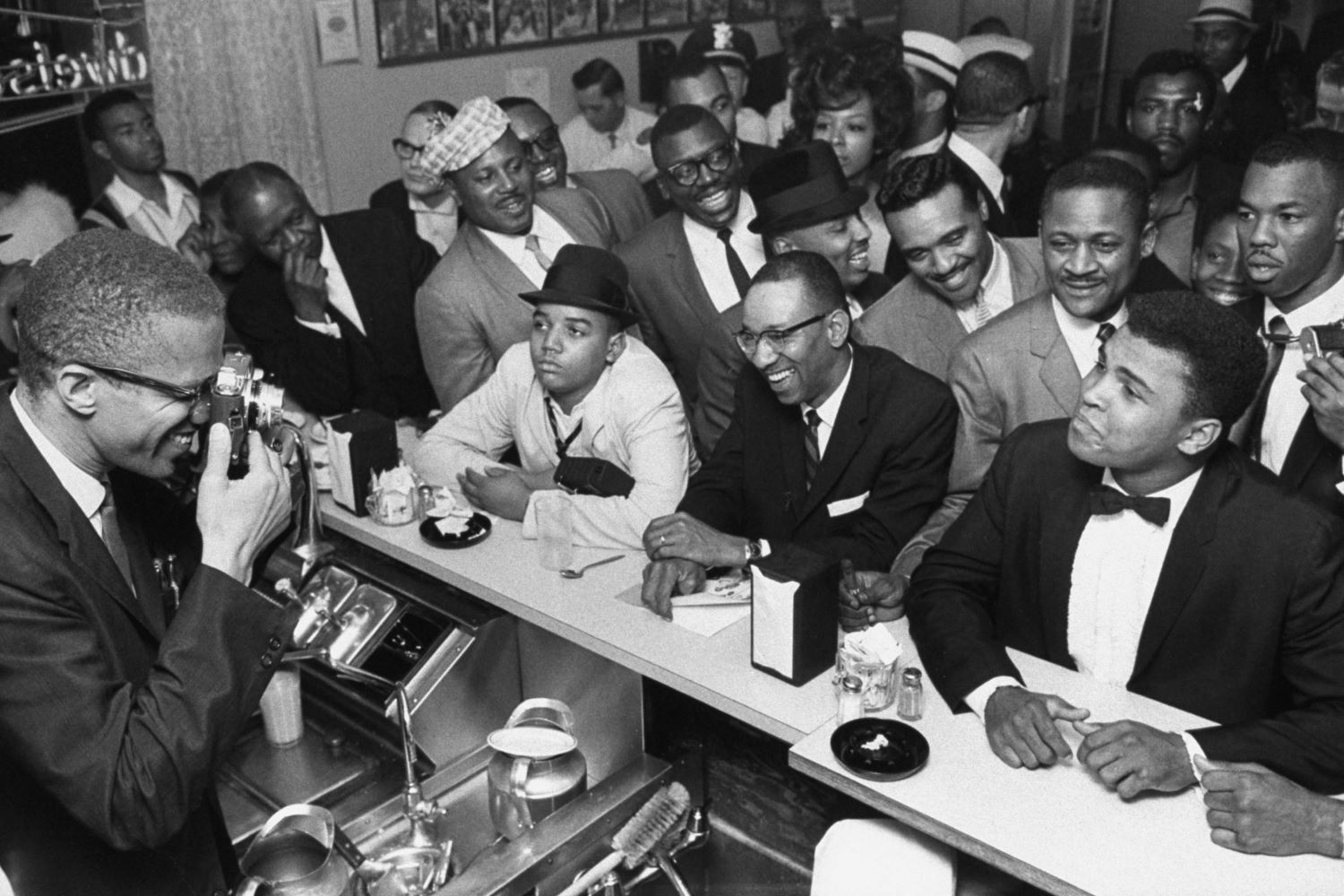 Black Muslim leader Malcolm X photographing Cassius Clay, Miami, 1964