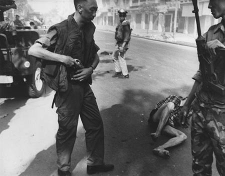 General holstering gun after execution, Saigon,1968