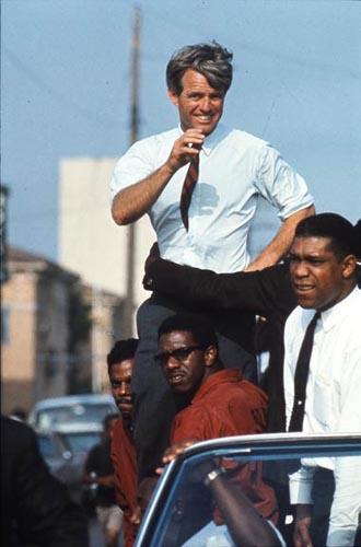 The Kennedy campaign travels through the Watts section of Los Angeles on the last day before the primary, 1968<br/>