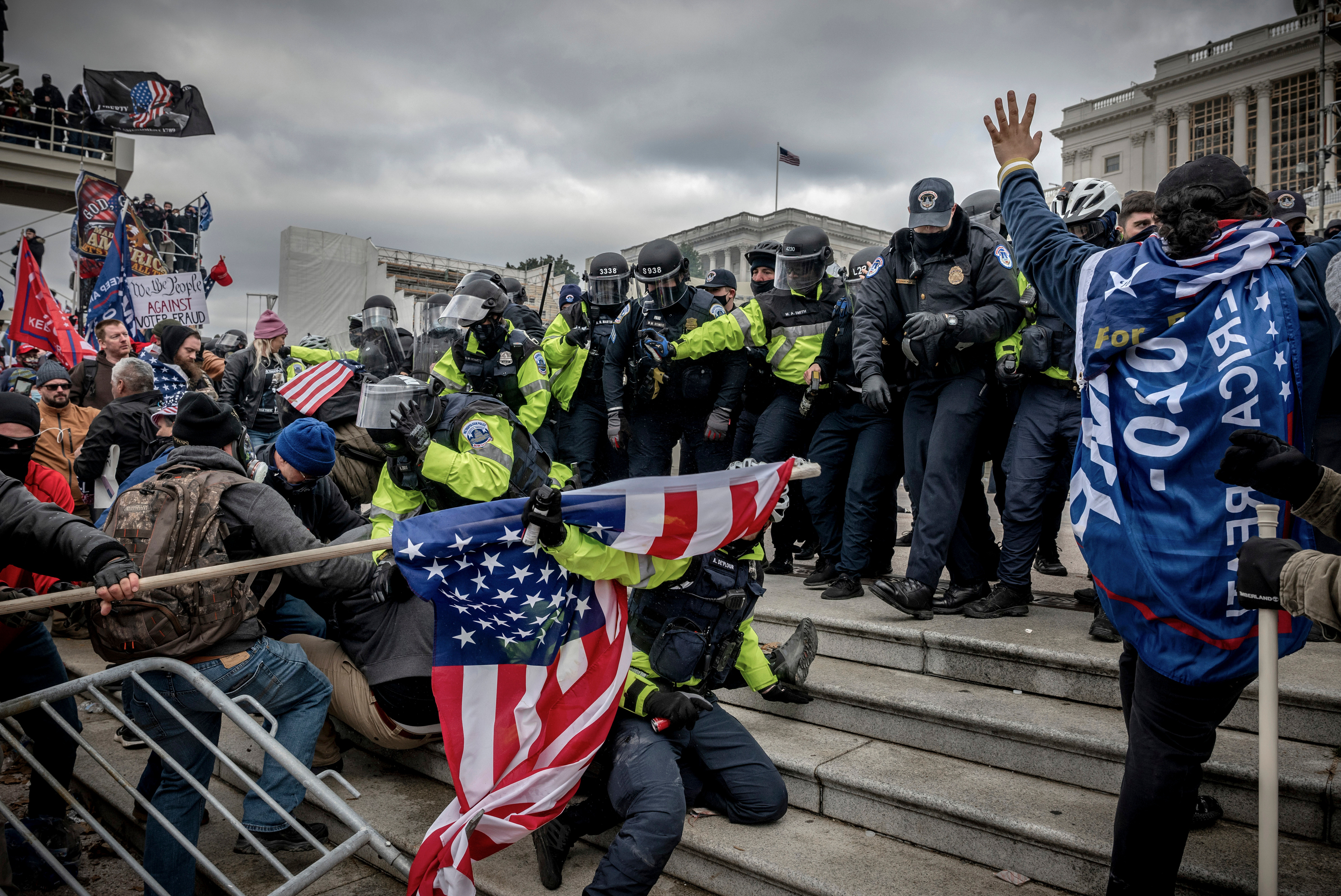 Trump supporters attacking police from the steps of the Capitol in Washington, DC on January 6, 2021
